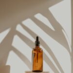 clear glass bottle on white wooden round table